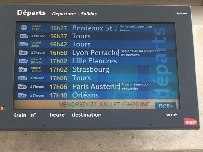 A departures screen in a French railway station
